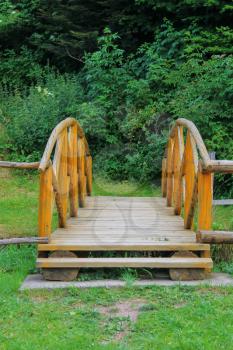 Wooden bridge trough small stream in Ukrainian Carpathians