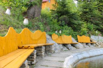 Original wooden benches on shore of lake in Ukrainian Carpathians
