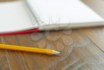 Yellow pencil memo notes organizer. Open notebook memories reminder. Education stationary closeup.