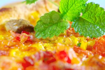 Hot pizza with mint spice leaf traditional food. Baked snack homemade eating. Green herb cooking closeup. Mushroom tomato vegetable ingredients.