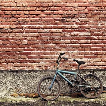 Royalty Free Photo of an Old Bike Against a Brick Wall