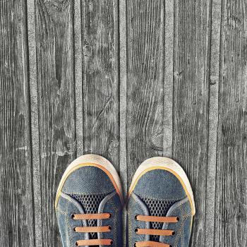 Hipster sneakers on a light wooden background
