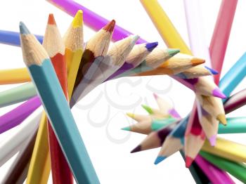 Spiral of colored pencils isolated on white background