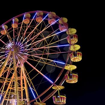 Ferris wheel with lights backlighting the night sky
