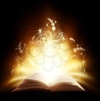 Magic open book with light and ornate on a black background