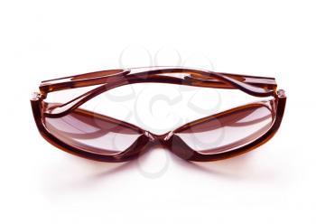 Brown folded fashion sunglasses isolated on white background