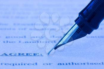 Royalty Free Photo of a Pen on an Agreement