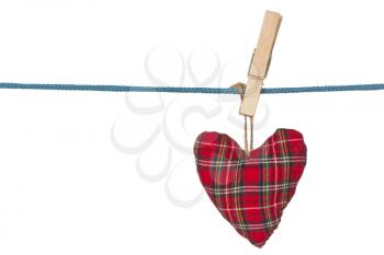 Red handmade heart hang on a clothes line 
