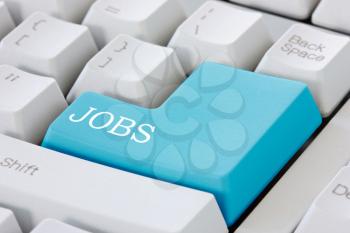 Searching for job on the internet. Jobs button on computer keyboard .