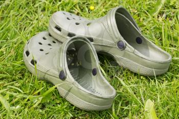 green rubber sandals on a green grass