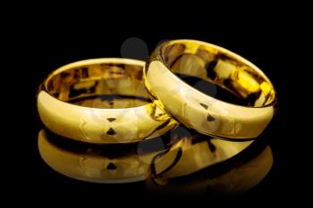 Golden wedding rings on a black  background