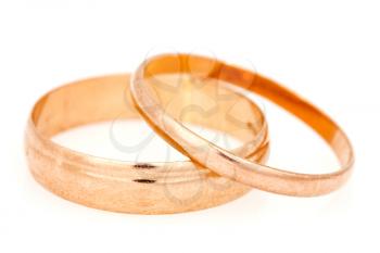 Golden wedding rings on a white background