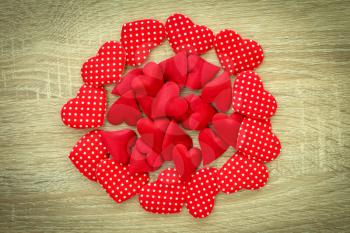 Red hearts pile on the wooden background