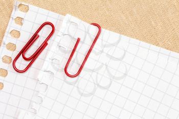 White paper sheet with red paper clips 