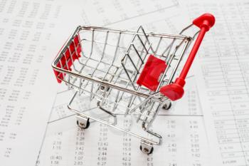 Empty shopping cart on a financial report