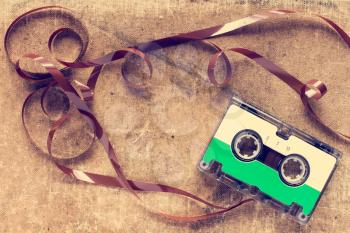Retro audio cassette with pulled out tape. Vintage image.