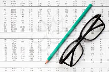 Pencil and glasses on financial chart.Accounting concept.