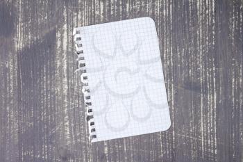 Blank notebook paper on grey wood background