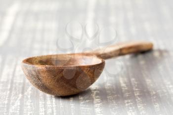 Wooden spoon on the grey wooden table
