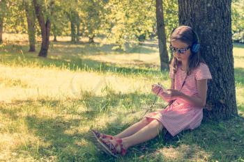 Cute girl listening to music from smartphone