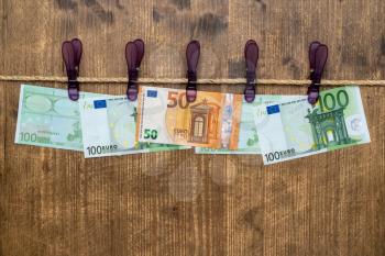 Euro banknotes hanging on a rope with clothes pins.Money laundering concept
