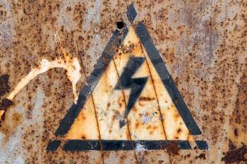 Old, rusty high voltage warning sign
