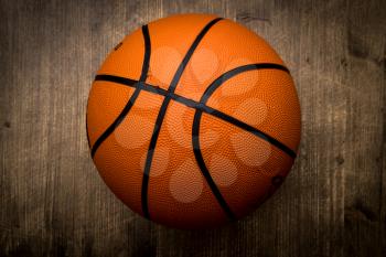 Basketball ball on dark wood background