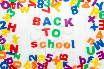 Sentence Back to school in colorful plastic letters 