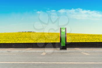 Electric car charging station with landscape background. Ecology and environment