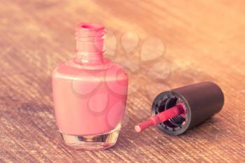 Bottle of nail polish on a wooden table