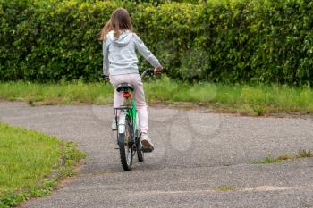 Rear view of a girl riding a bicycle