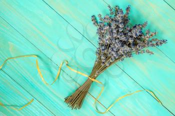  Bunch of dry lavender flowers on the blue wooden background