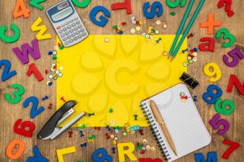 School supplies or stationery accessories with blank yellow paper sheet for copy-space