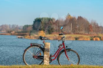 Stationary bicycle on cycle path with amazing scenic views of a lake & park