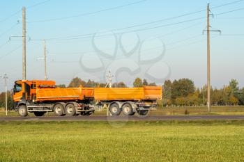  Orange dump truck goes on country highway