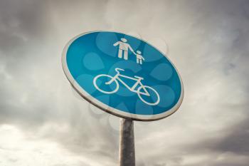 Cyclist & pedestrian road sign on the sky background