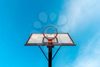 Basketball hoop against clear sky background. View from bottom.