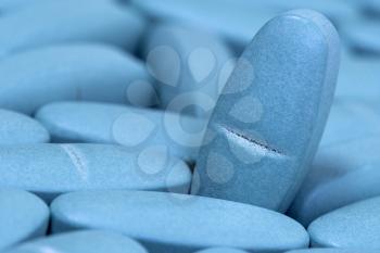 Medical blue pills macro background. Medicine concept of viagra, medication for stomach, erection, sleeping, digestive, drugs.