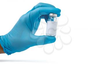 Doctor, nurse or scientist hand in blue nitrile gloves holding flu, measles, coronavirus (COVID-19) vaccine. Medicine and drug concept. Copy space.