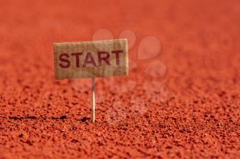 START sign on running track rubber cover. Close up view.