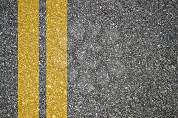 Pattern of asphalt texture with twoyellow lines