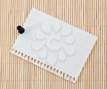 Spiral paper with clip on bamboo background