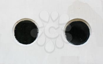 Two porthole on the metal wall