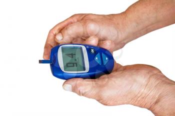 Blue meter with readings of blood sugar in the hands of an elderly woman isolated on white background