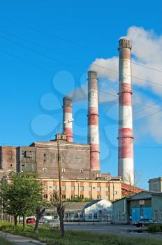 Pipes and building hydropower plants on the background of blue sky in the town of Serov