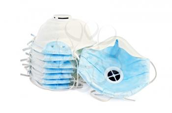 A stack of white and one detached disposable respirators with blue detail isolated on white background