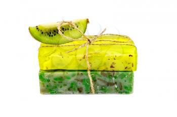 Two green homemade soap with a slice of kiwi isolated on white background