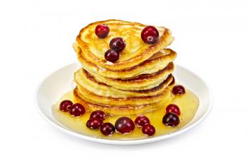 A stack of pancakes with cranberries and honey on a plate isolated on white background