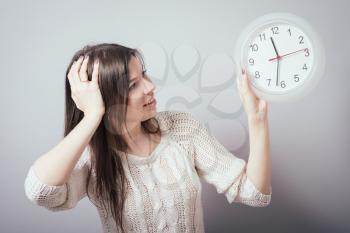 girl holding a clock
