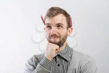 young man with a pencil behind his ear